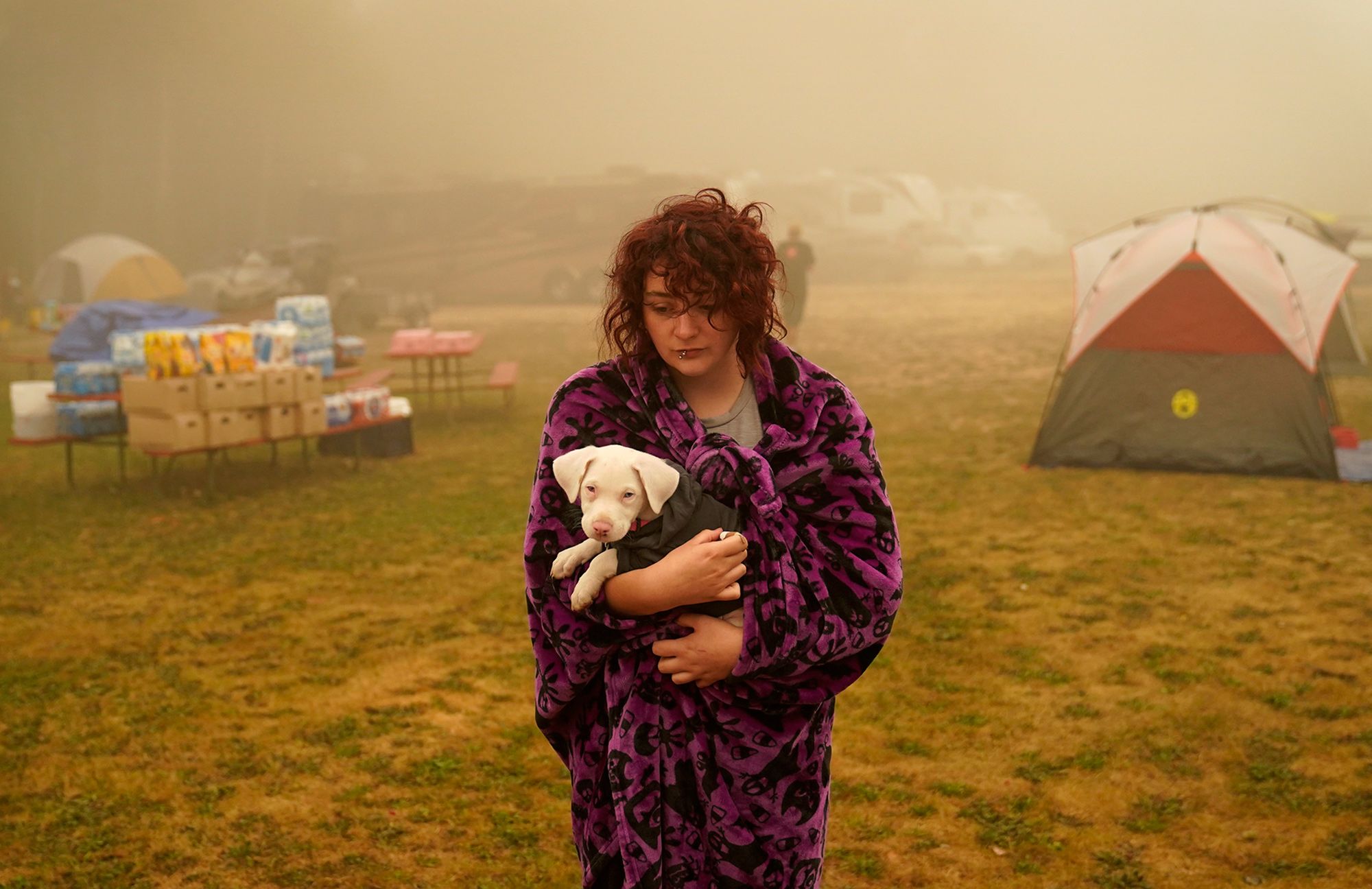 Shayanne Summers holds her dog Toph on Sept. 13 after several days at an evacuation center at the Milwaukie-Portland Elks Lodge in Oak Grove, Ore.