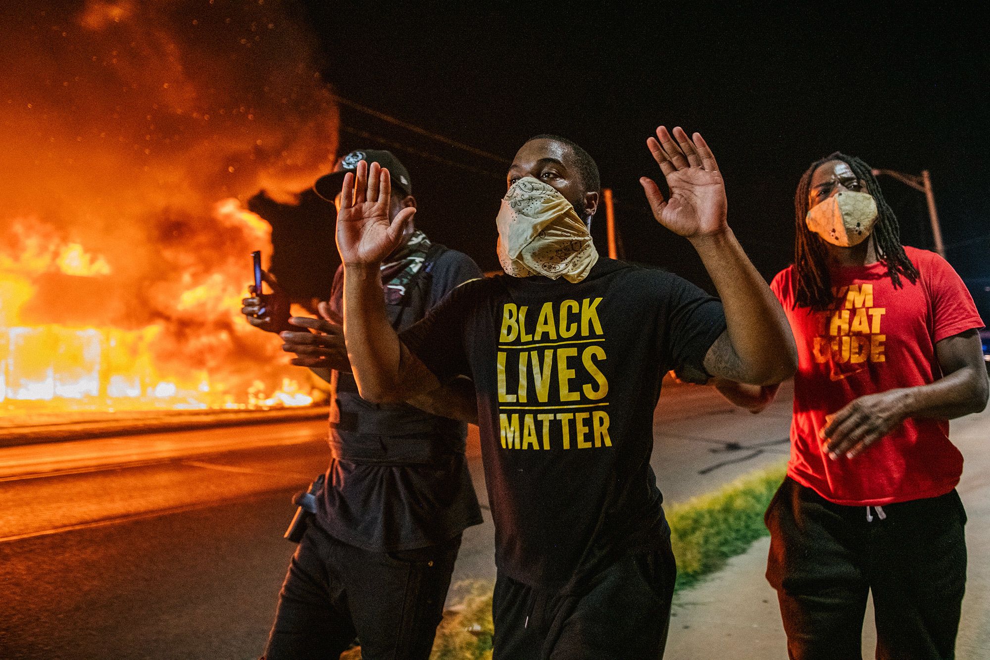 Men walk towards law enforcement with their hands up on in Kenosha, Wis., on Aug. 24, during a second night of civil unrest following the shooting of Jacob Blake, a Black man shot seven times in the back by police.