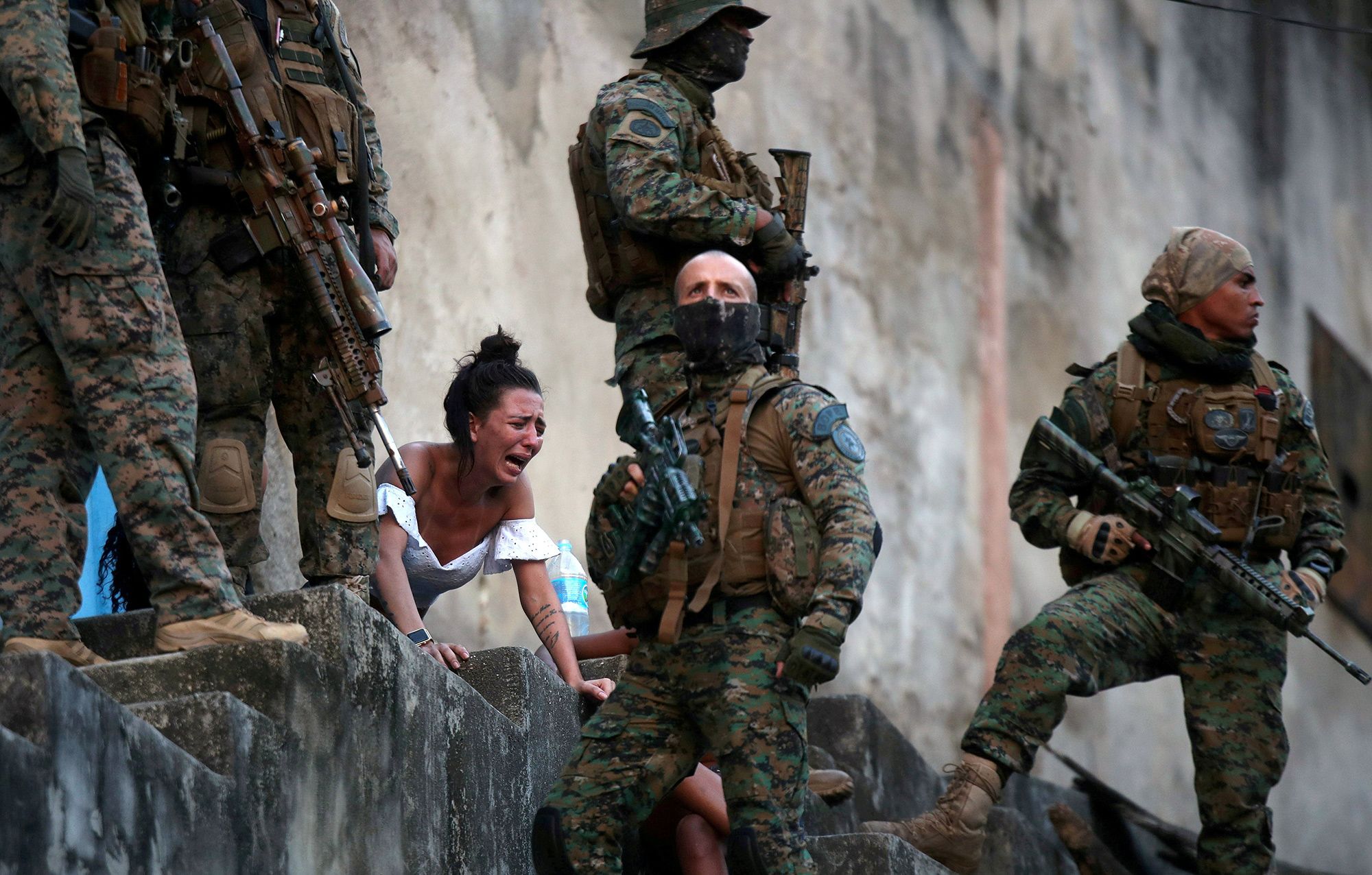Juliana, who said she was four months pregnant, screams in front of her husband's body after he who was shot near the Sao Carlos favela complex during a police operation following confrontation between drug gangs in Rio de Janeiro on Aug. 27.