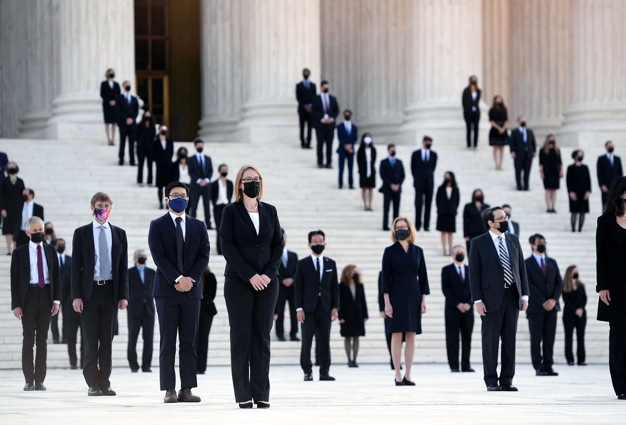 Former clerks for Supreme Court Justice Ruth Bader Ginsburg wait for her casket to arrive at the Supreme Court on Sept. 23.