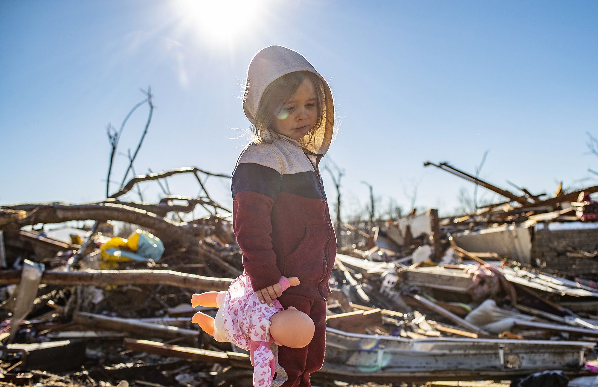 Desiray Cartledge, 3, stands in the rubble of her house in Dawson Springs, Ky., on Dec. 12.