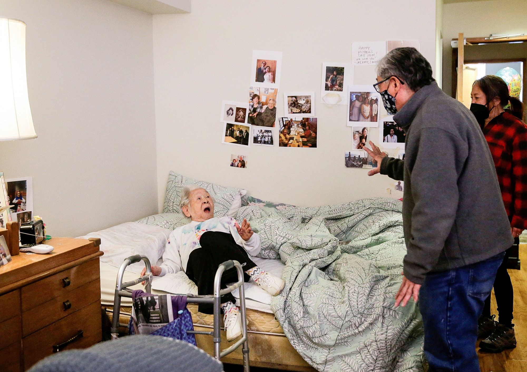 Yoshia Uomoto, 98, reacts as her son Mark Uomoto and niece Gail Yamada surprise her with their first in-person visit in a year after Covid-19 restrictions were lifted at Nikkei Manor
