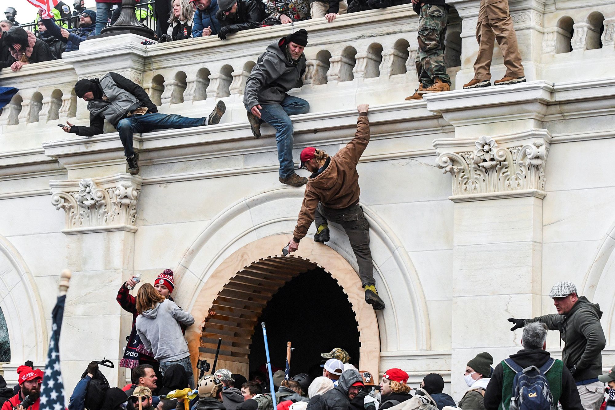 Supporters of President Donald Trump climb the walls at the U.S. Capitol during a protest against the certification of the 2020 presidential election results on Jan. 6.