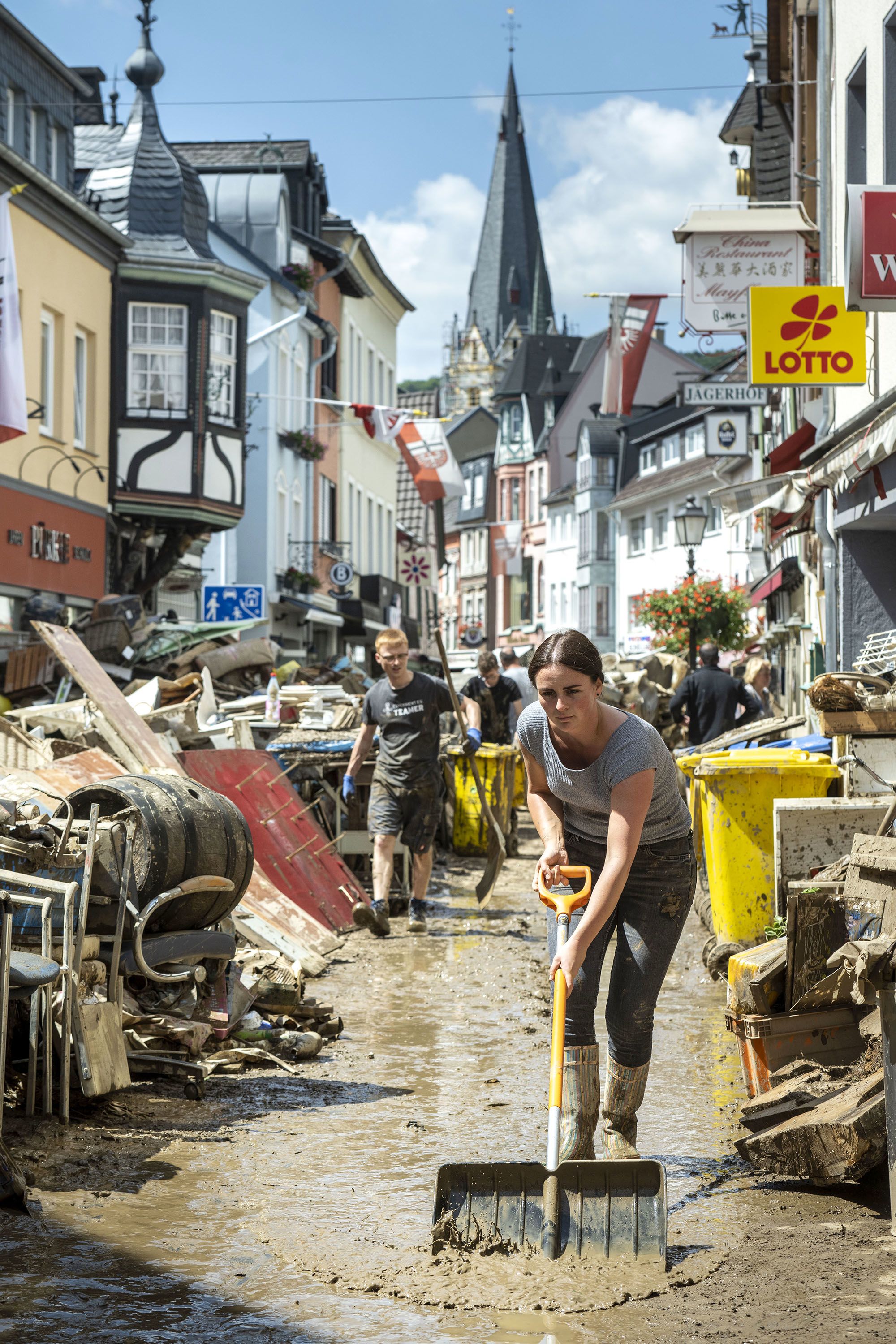 Volunteers and residents clean up their shops and restaurants following severe flash flooding in Bad Neuenahr-Ahrweiler, Germany, on July 18