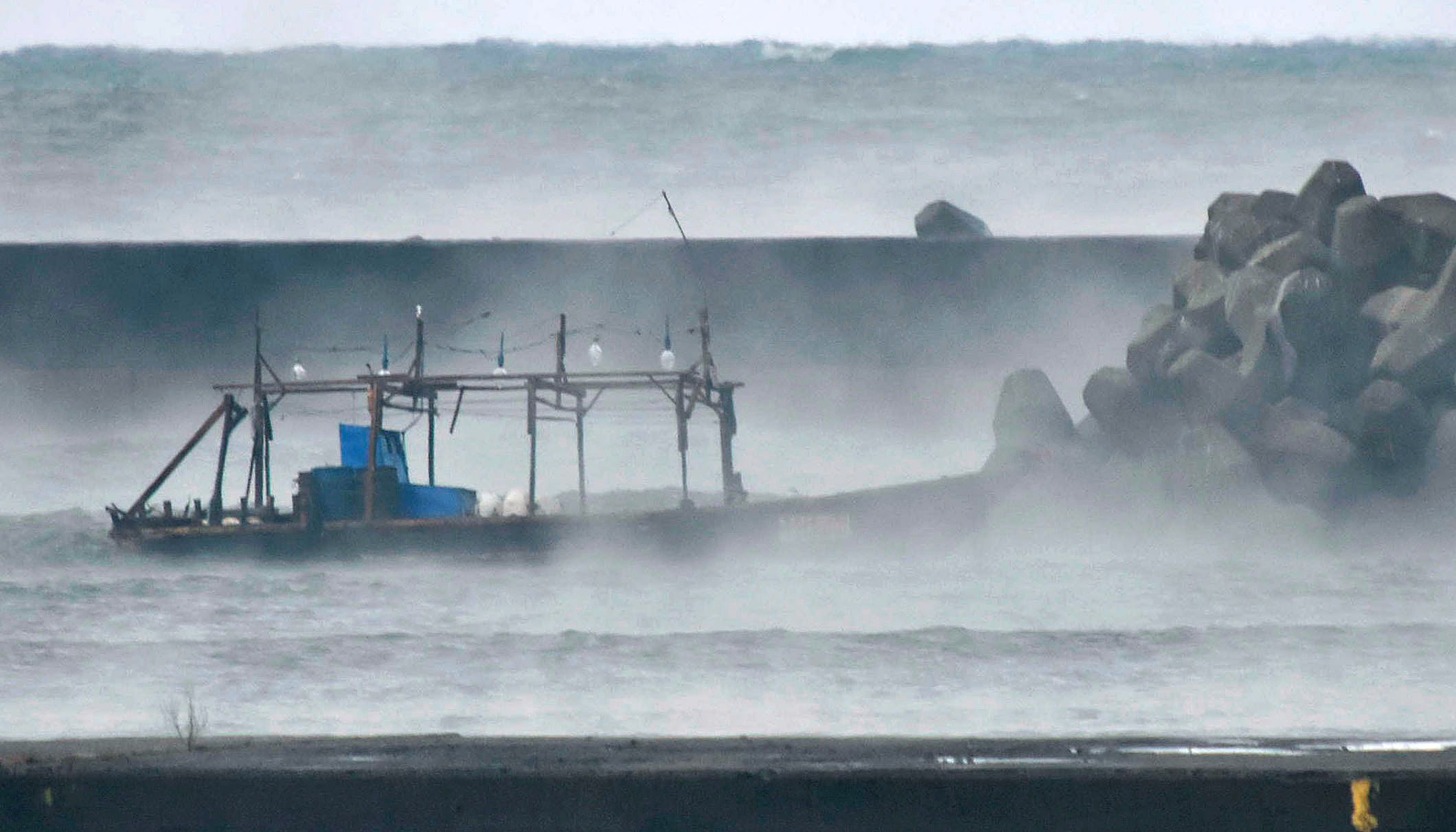 A wooden boat is seen in front of a breakwater in Yurihonjo, Akita prefecture, Japan on Nov. 24, 2017.