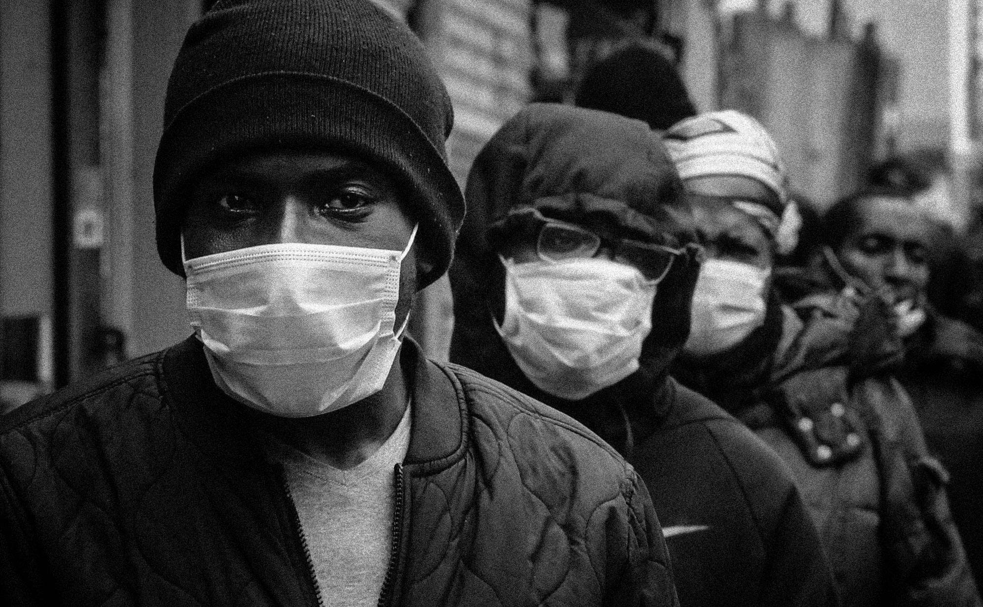 Residents wait for food and mask distribution from Rev. Al Sharpton in Harlem, N.Y., on April 18, 2020. (Bebeto Matthews / AP file)