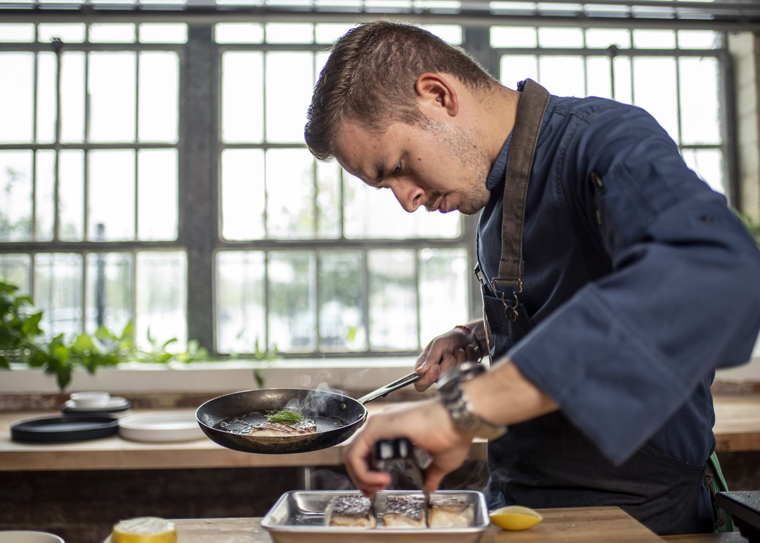 Chef Omar Pereney places fish onto a tray at his test kitchen in Houston on Sept. 13. (Sergio Flores for NBC News)