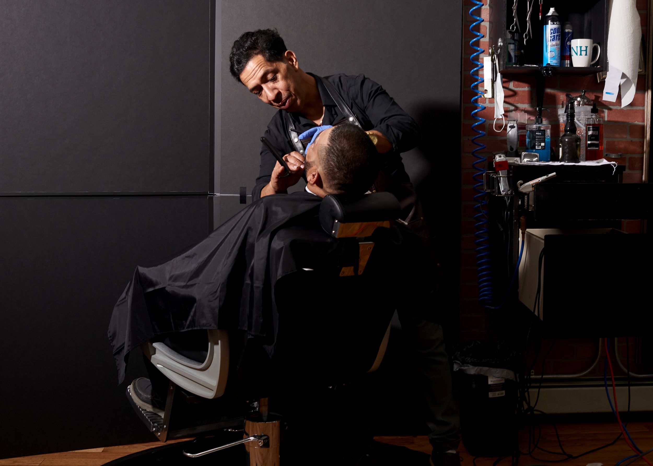 Rafael Almonte with a customer at La Fama, his barbershop, in Nashua, N.H, on Sept. 11. (Philip Keith for NBC News)