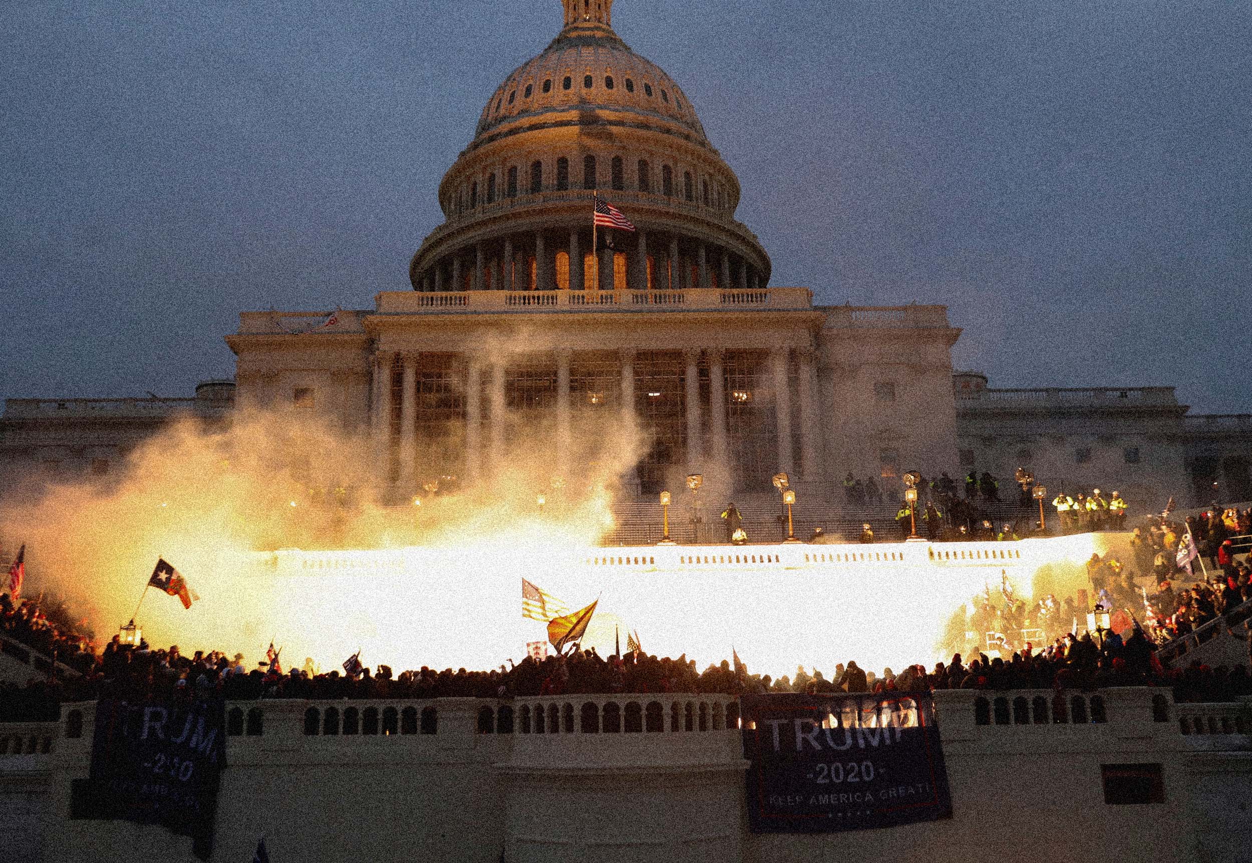Flashes of light from police munition illuminate the Capitol and protesters. (Leah Millis / Reuters file)