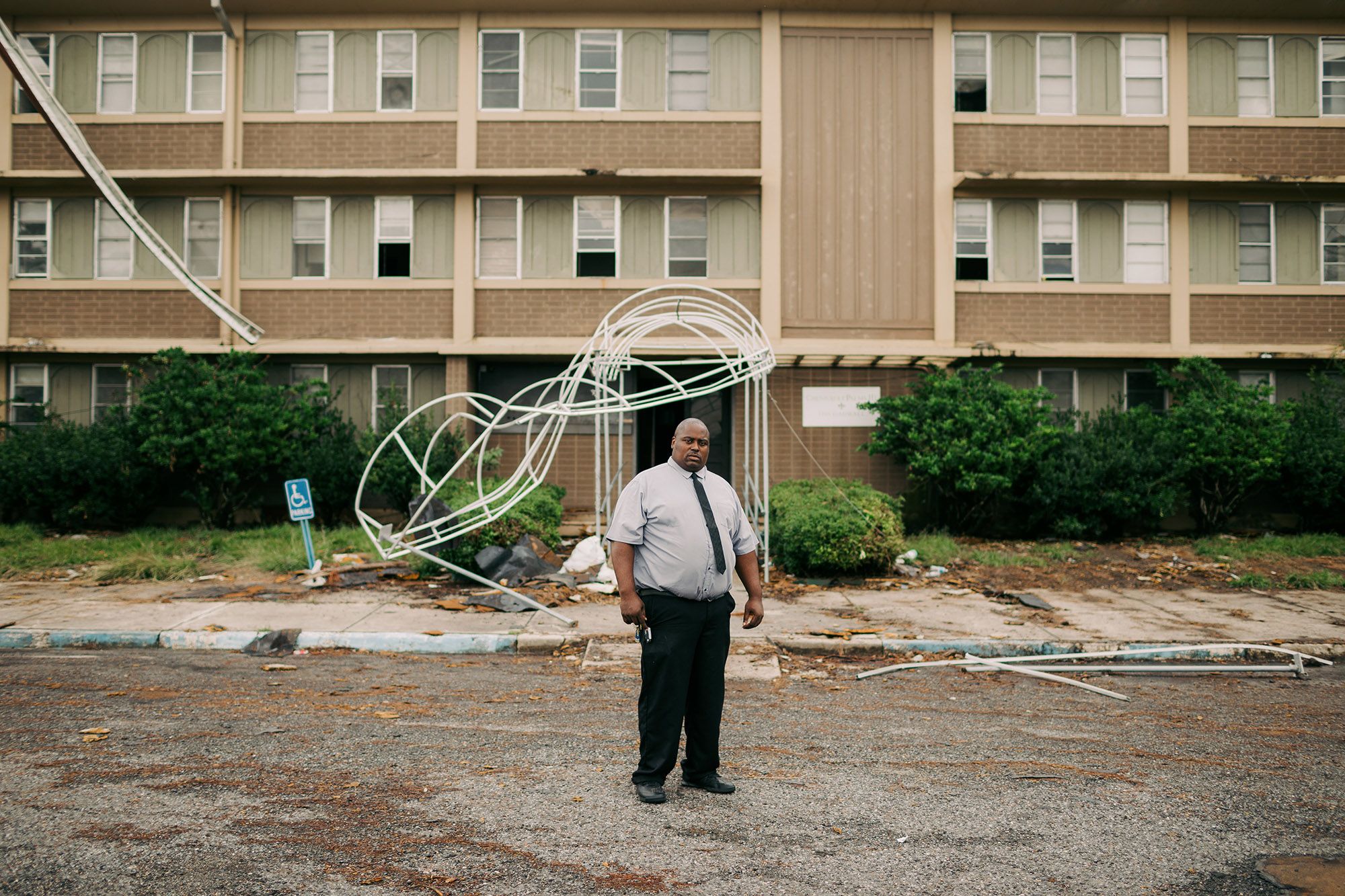Cory Mackey stands in front of the apartment complex where he used to live before he was displaced due to damage from the hurricanes in Lake Charles, La. (Bryan Tarnowski for NBC News)