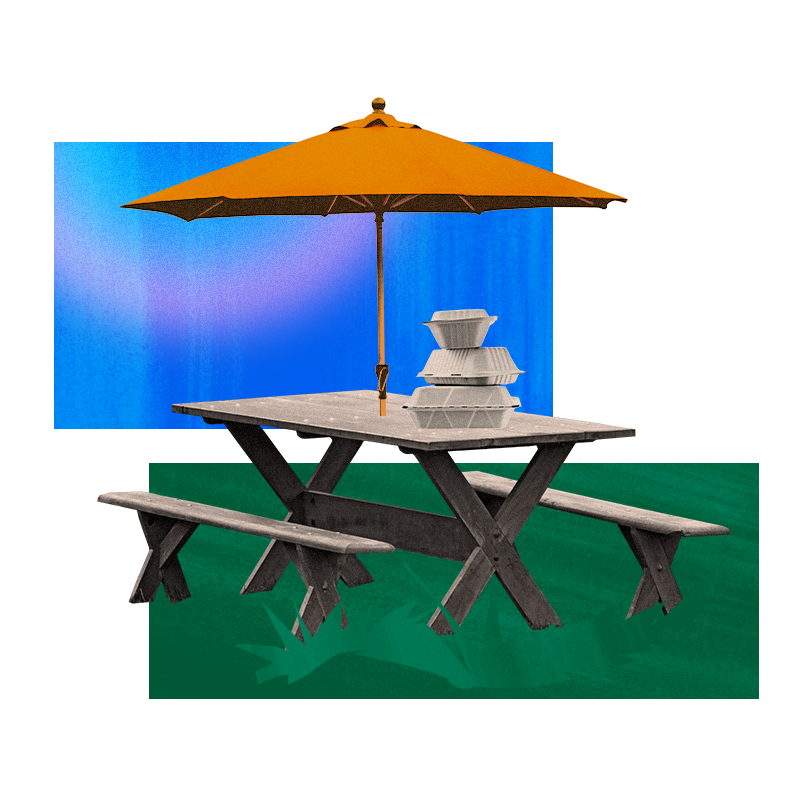 Outdoor dining set up with umbrella and takeout containers
