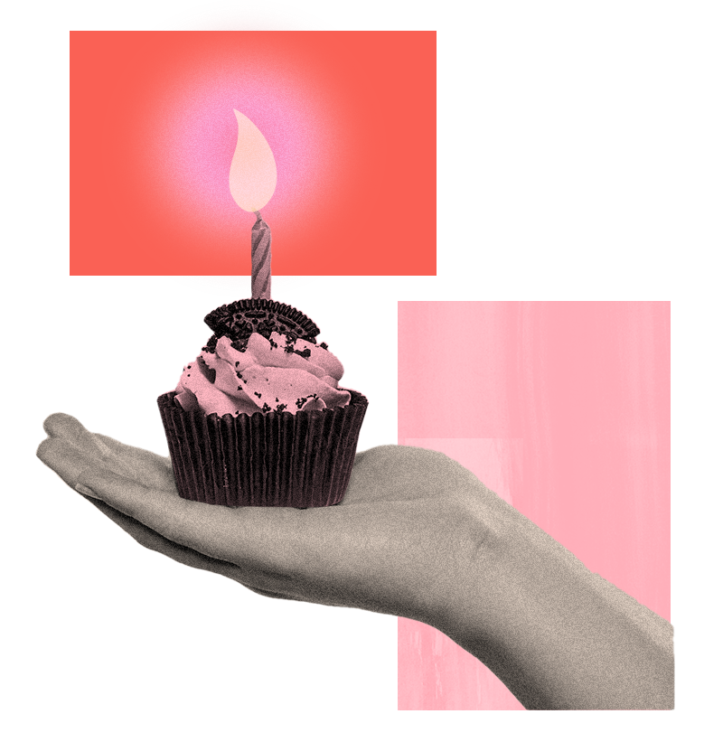 Hand holding cupcake with birthday candle