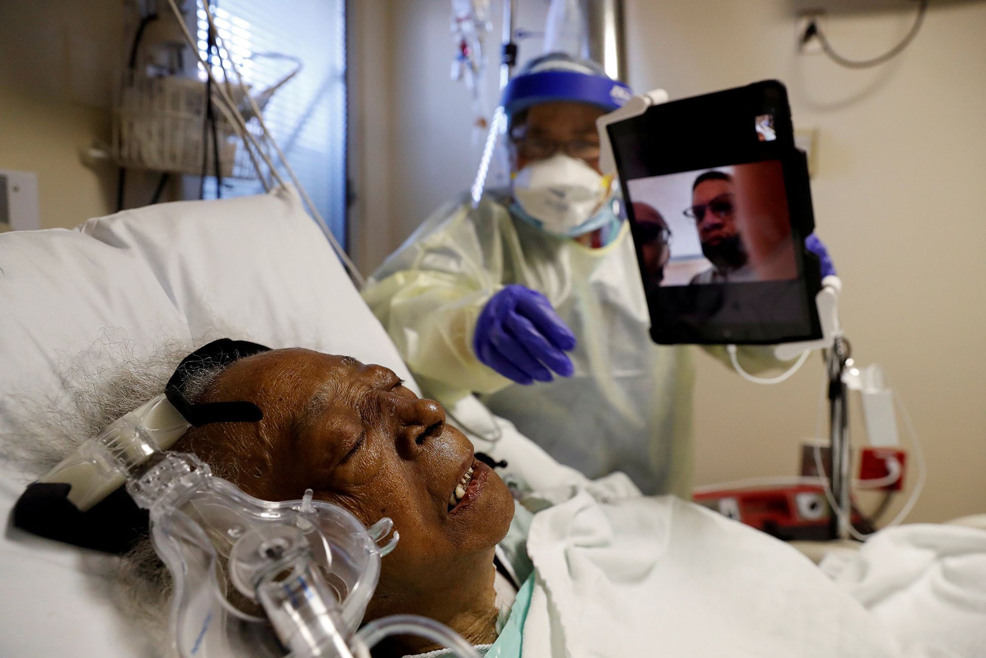Florence Bolton, 85, a Covid-19 patient, lies in her intensive care bed as family members attempt to communicate via video at Roseland Community Hospital on the South Side of Chicago.