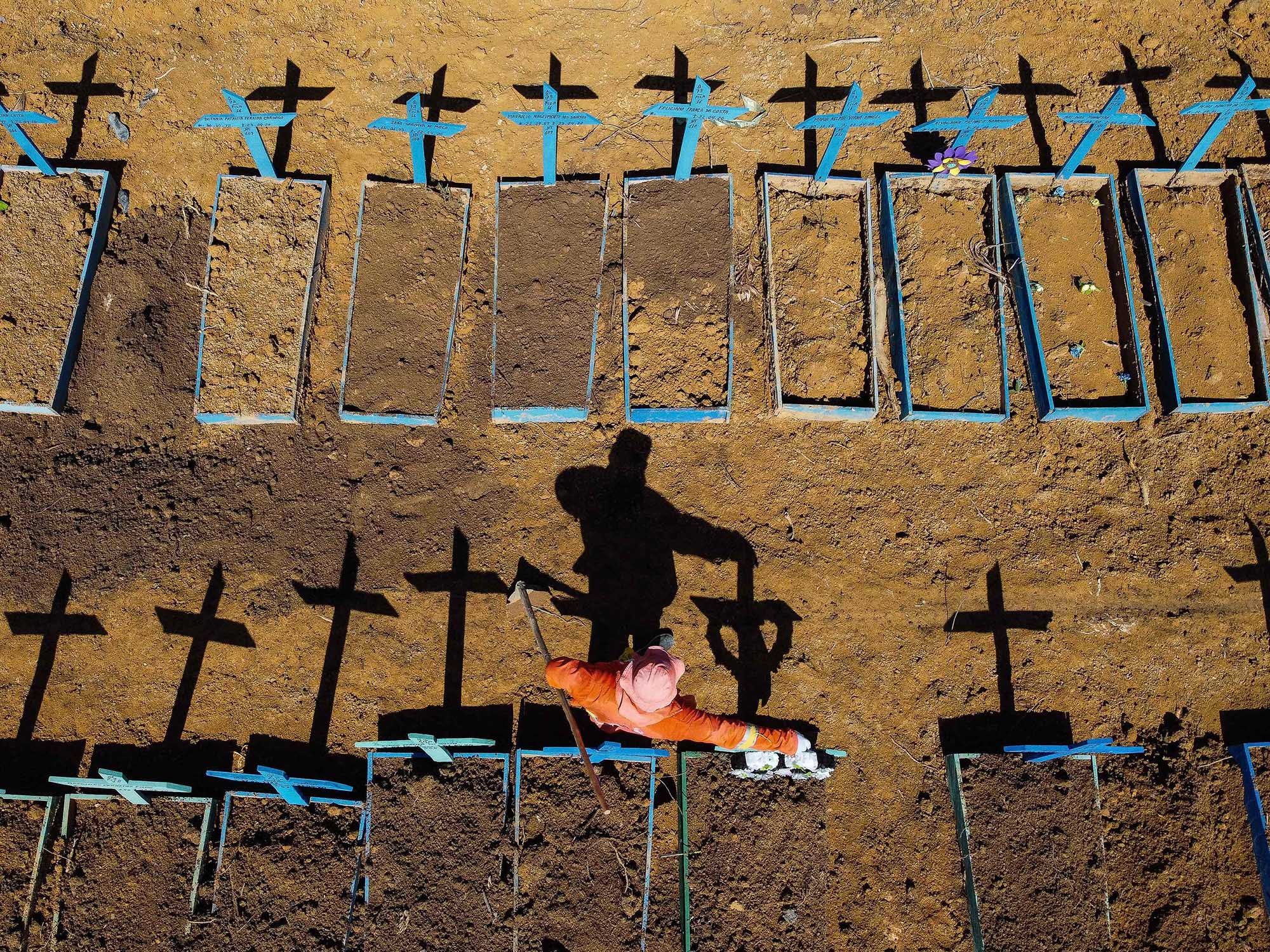 A gravedigger stands at the Nossa Senhora Aparecida cemetery where Covid-19 victims are buried daily in Manaus, Brazil.