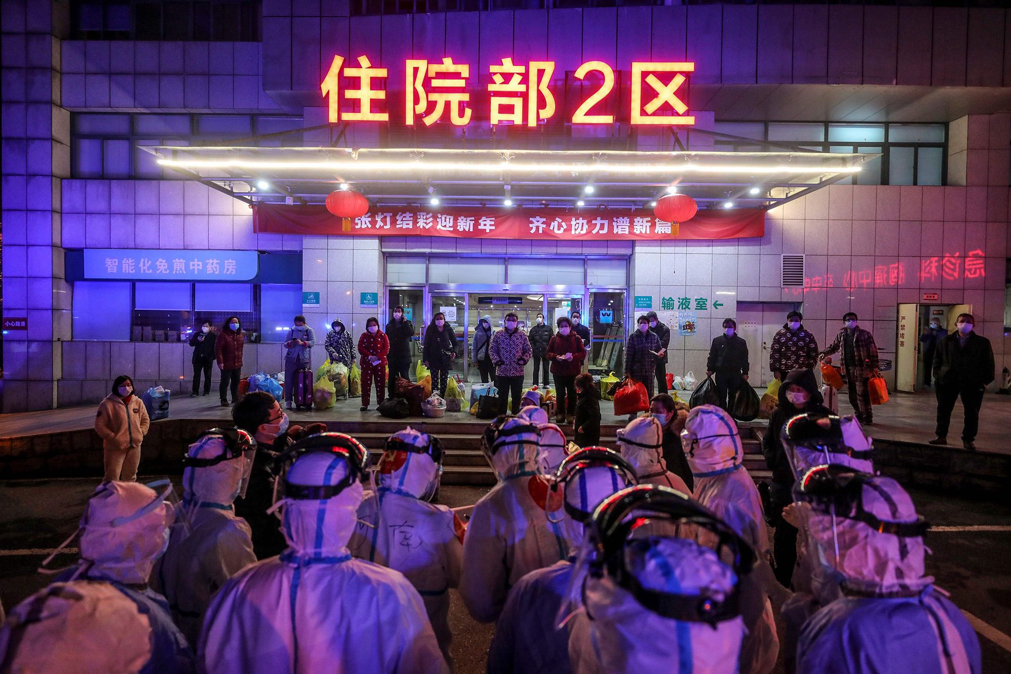 Covid-19 patients wait to be transferred from Wuhan No. 5 Hospital to Leishenshan Hospital, the newly-built hospital for coronavirus patients in Wuhan.