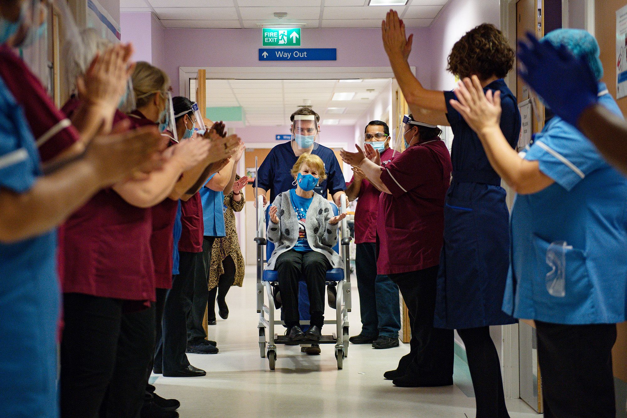 Margaret Keenan, 90, is applauded by staff as she returns to her ward after becoming the first person in the United Kingdom to receive the Pfizer/BioNtech Covid-19 vaccine at University Hospital in Coventry.