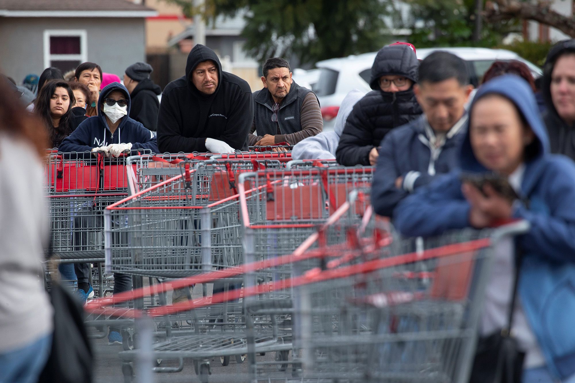 Hundreds of shoppers line up for blocks to purchase supplies at a Costco in Garden Grove, Calif., on March 14. (Mike Blake / Reuters)